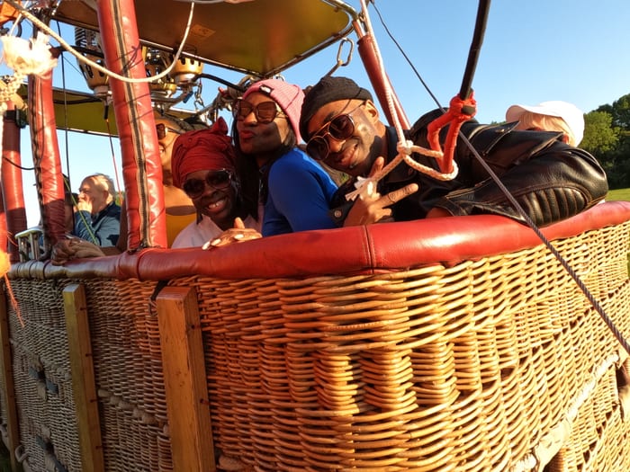 Passengers smiling together in a Virgin hot air balloon basket