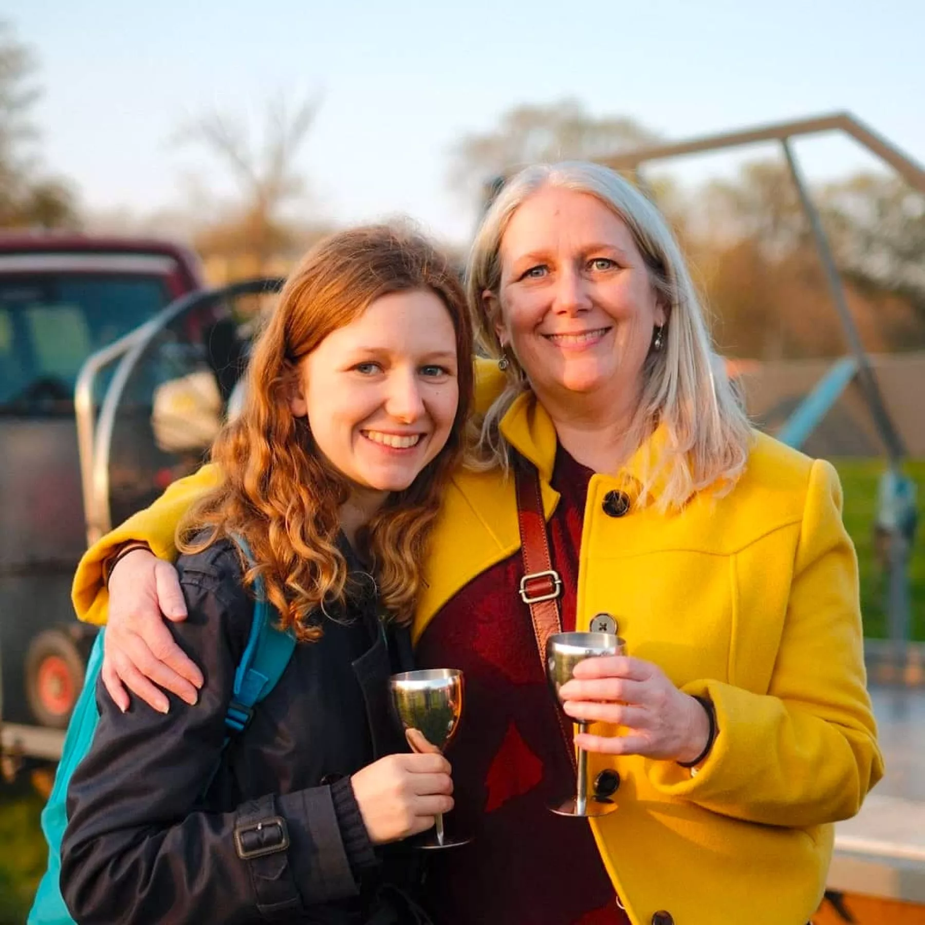 Two women happy and smiling as they toast their prosecco after a hot air balloon ride